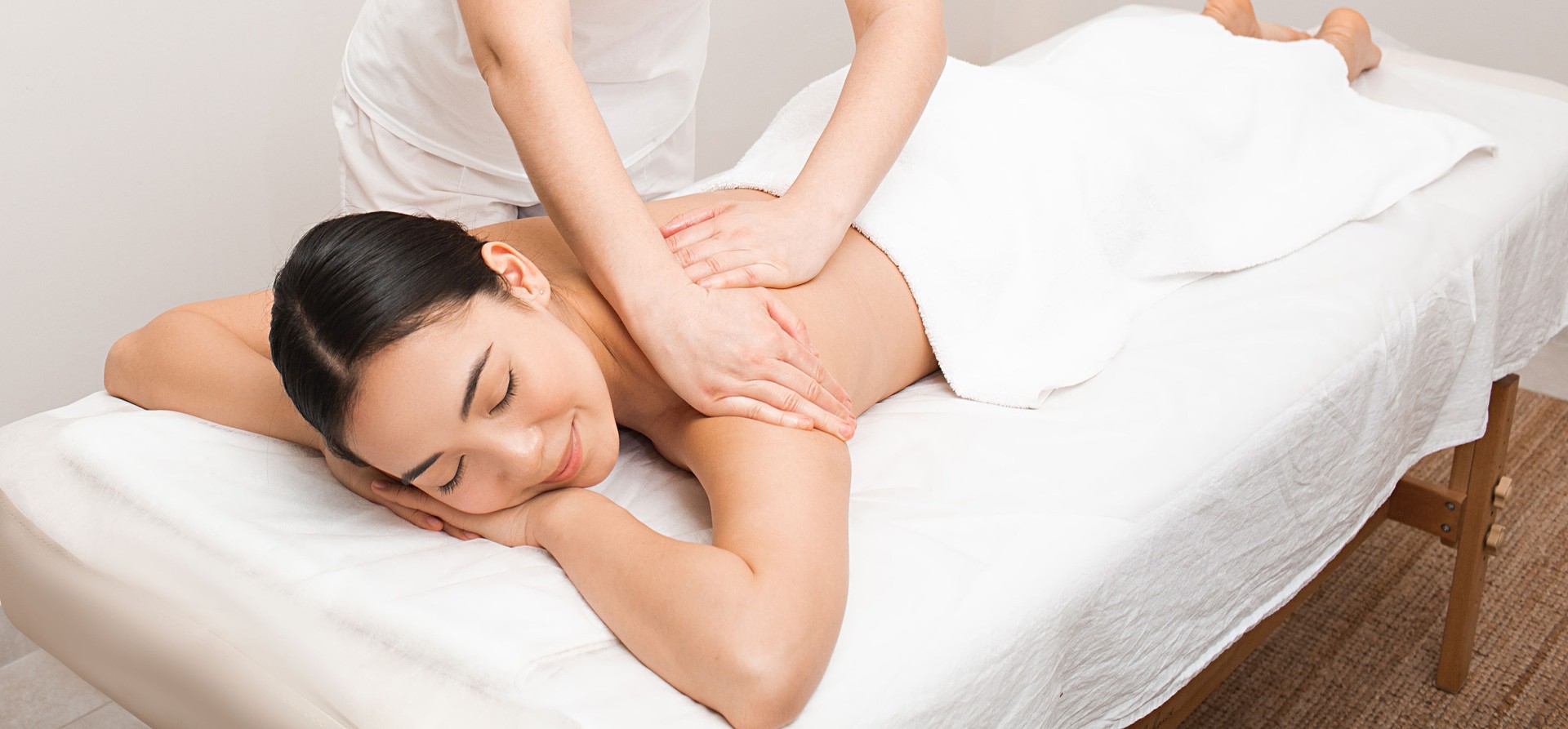 Beautiful woman enjoying a massage at the spa. Relaxing massage at spa
